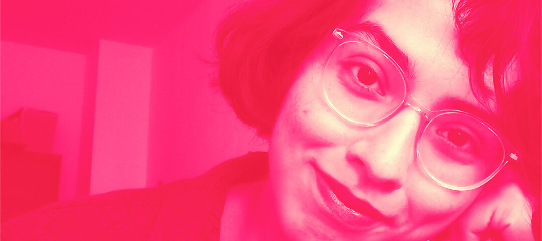 pink self portrait of young woman with glasses